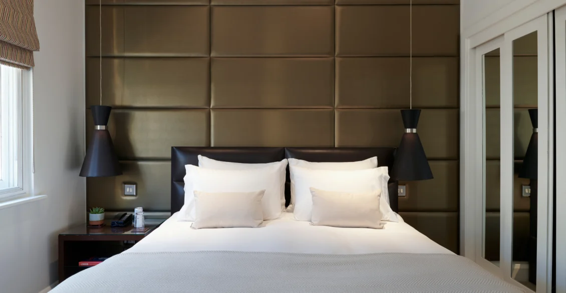 Premium King room with a padded headboard, pendant lights and a king bed