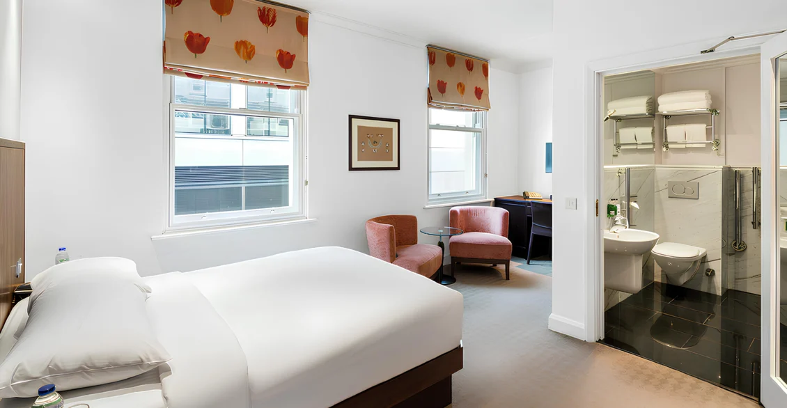 Accessible Double room with a double bed, armchair and open bathroom