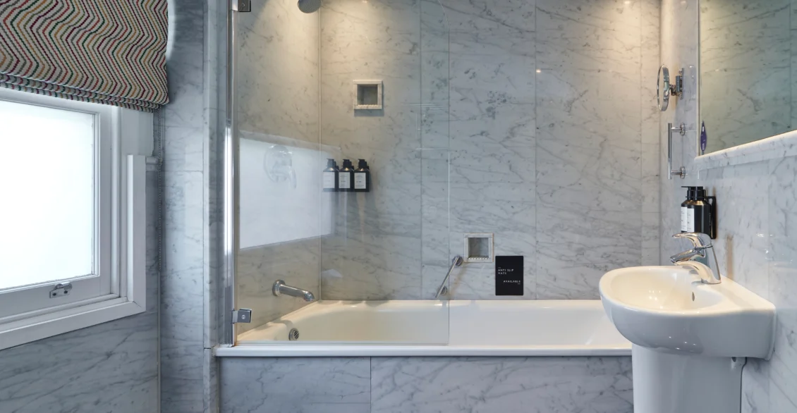 Marble bathroom with bath, rainfall shower and basin
