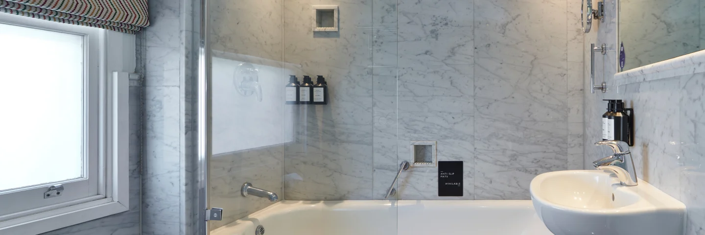 Marble bathroom with bath, rainfall shower and basin