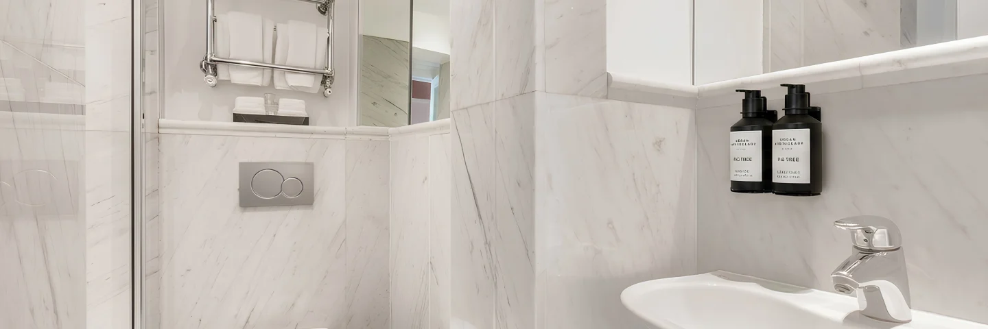 Marble bathroom with basin, towel rail and toiletries