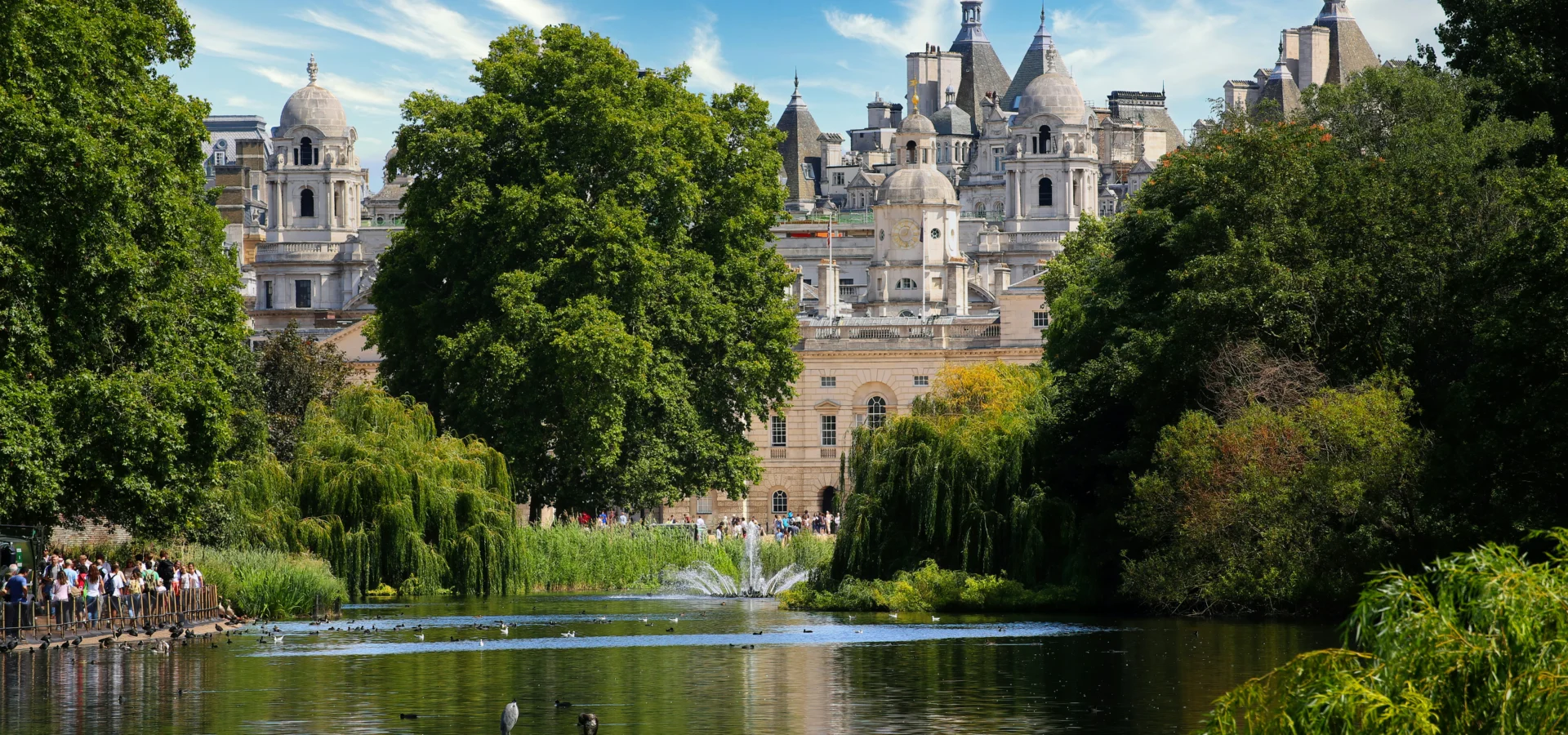 Lake and trees in Hyde Park with buildings beyond