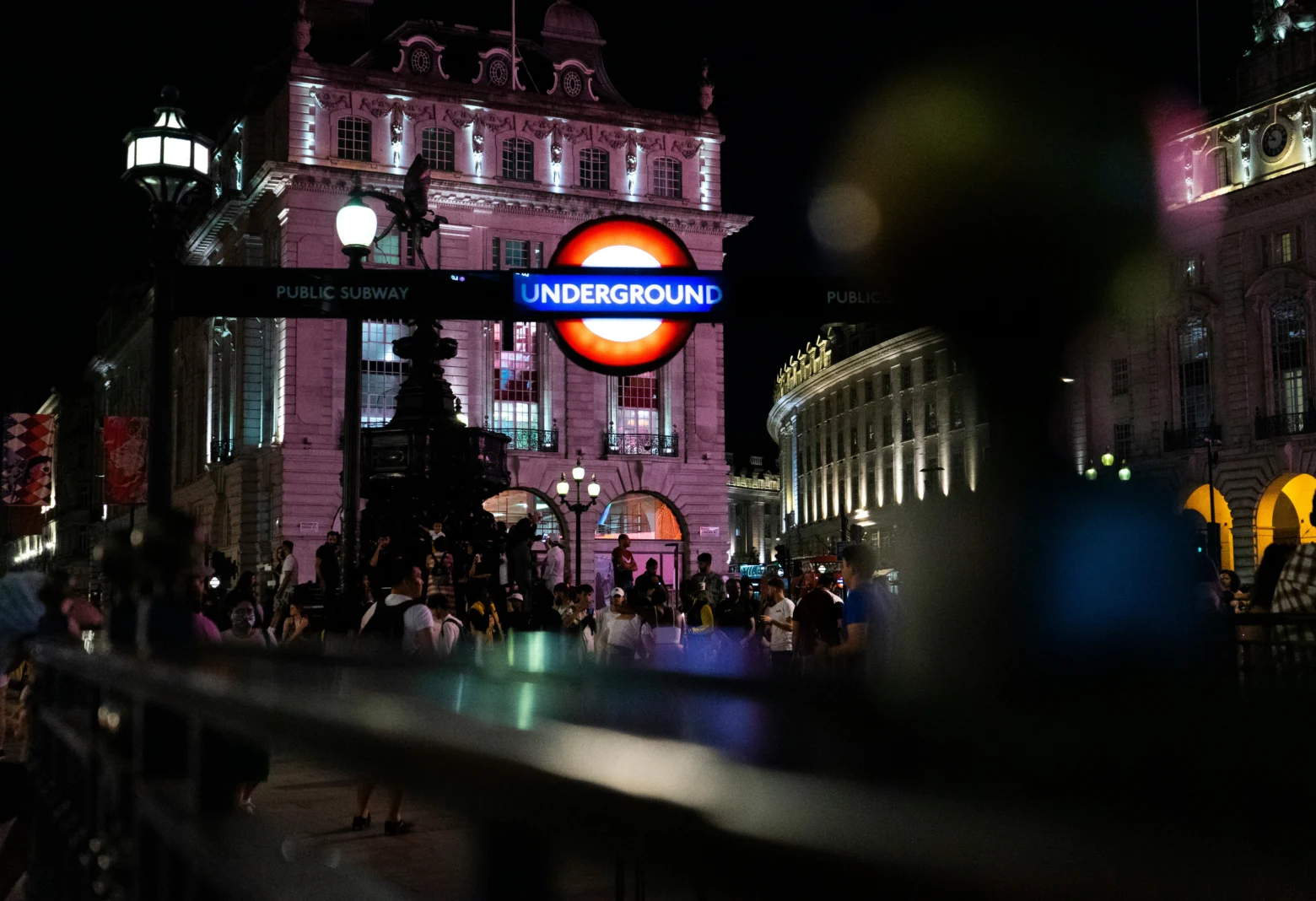 London Underground roundel sign at Piccadilly Circus at night