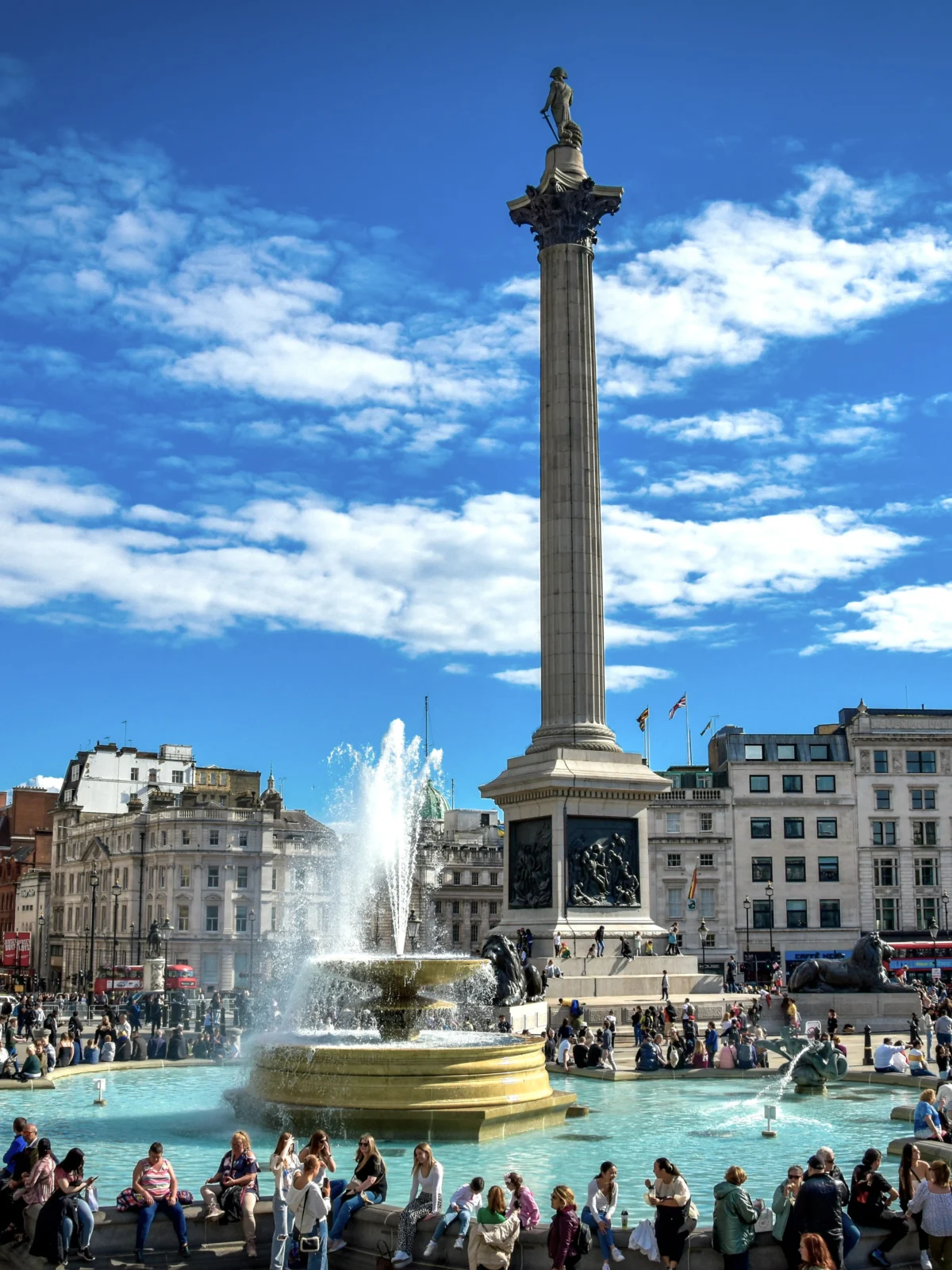 Trafalgar Square fountain with Nelson's Column behind on a sunny day