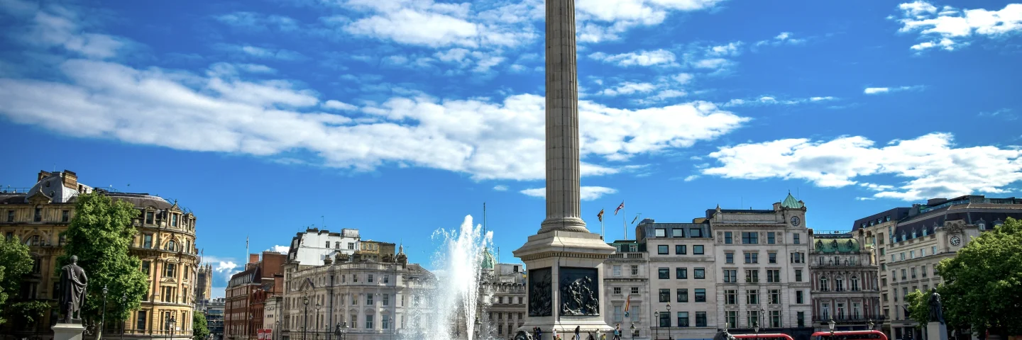 Trafalgar Square fountain with Nelson's Column behind on a sunny day