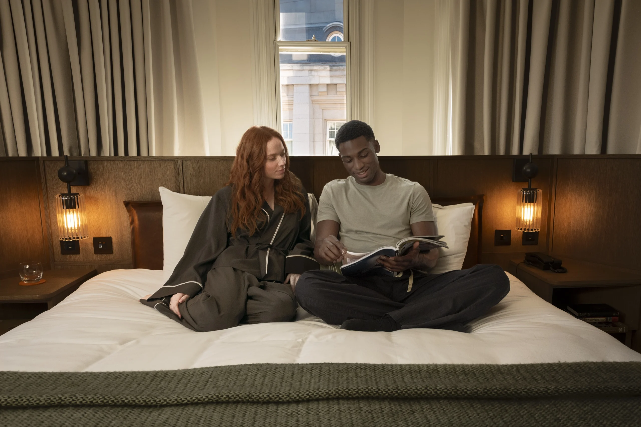 Guests relaxing on a bed at Guild Hotels Bloomsbury
