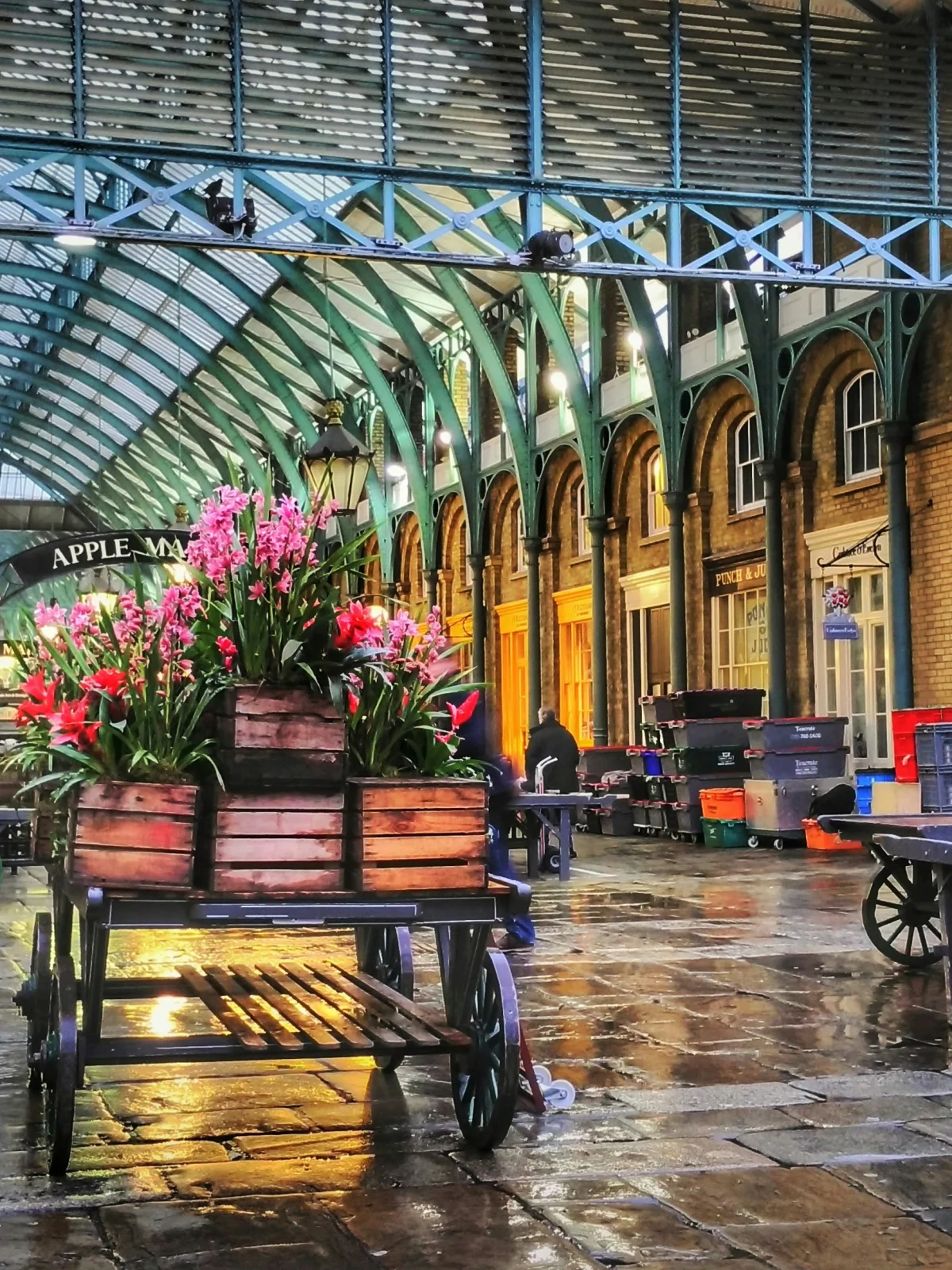 Flower carts beneath the covered roof of Covent Garden Market