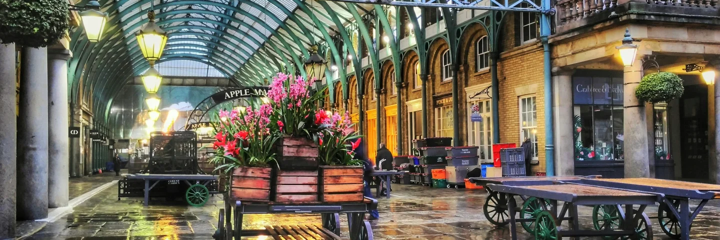 Flower carts beneath the covered roof of Covent Garden Market