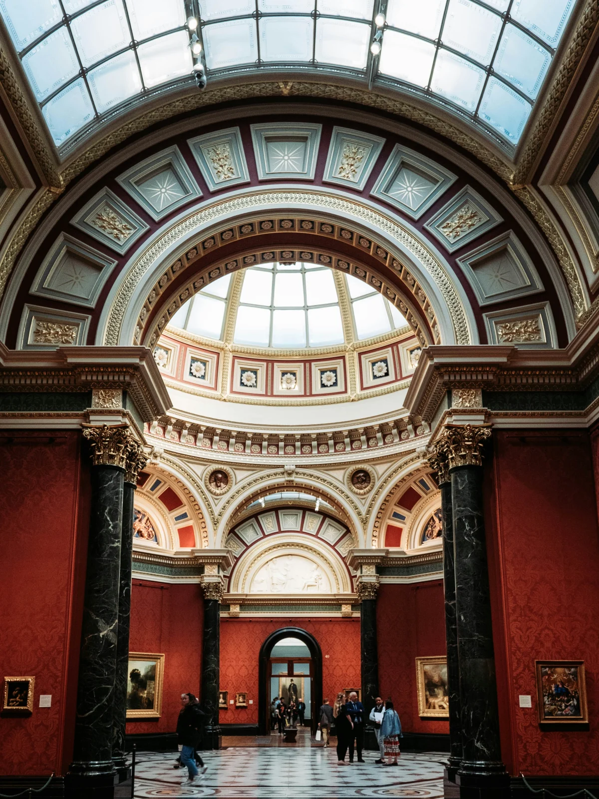 Ornate domed interior and red gallery walls at the National Gallery