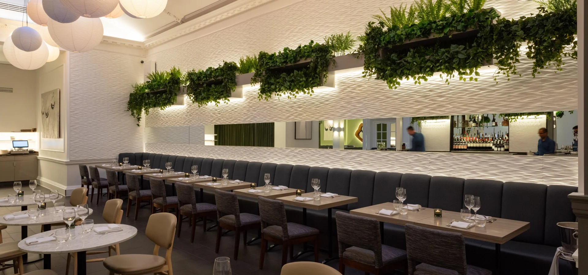 Steak & Lobster Fitzrovia dining room with lanterns, skylight, planters and banquette seating
