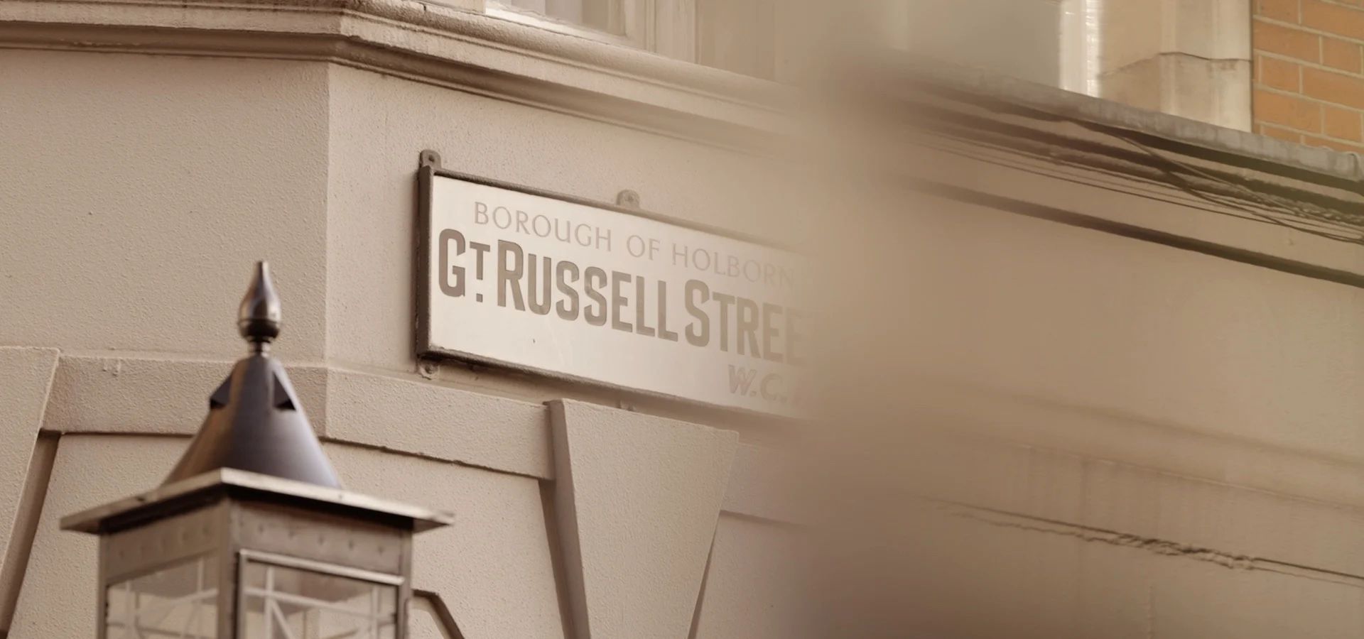 Great Russell Street sign on the corner of a Bloomsbury building above a lantern